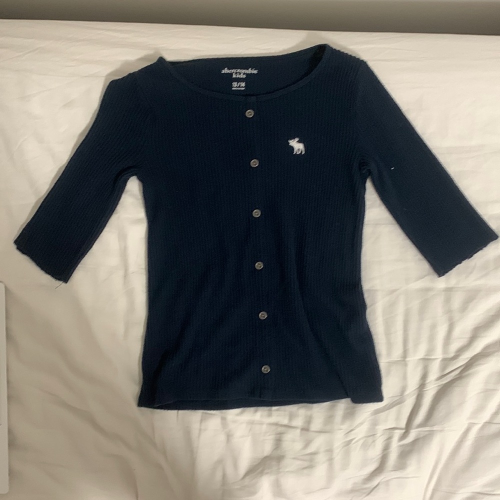 This is a dark blue shirt from Abercrombie Kids.